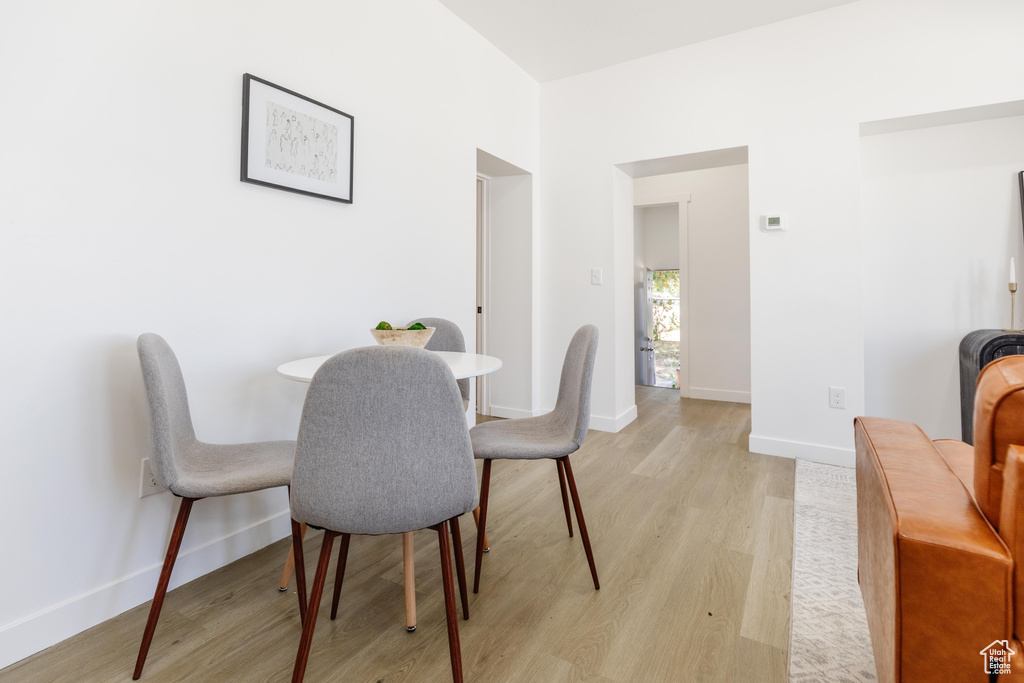 Dining room featuring light wood-type flooring and baseboards