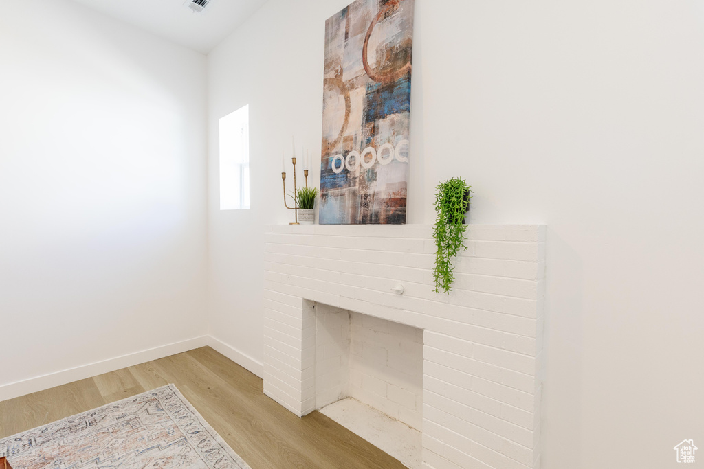 Living area featuring light wood-type flooring and baseboards