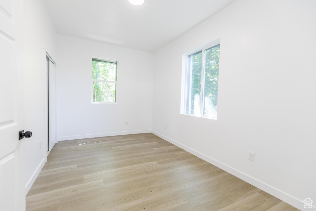 Unfurnished bedroom with light wood-style flooring