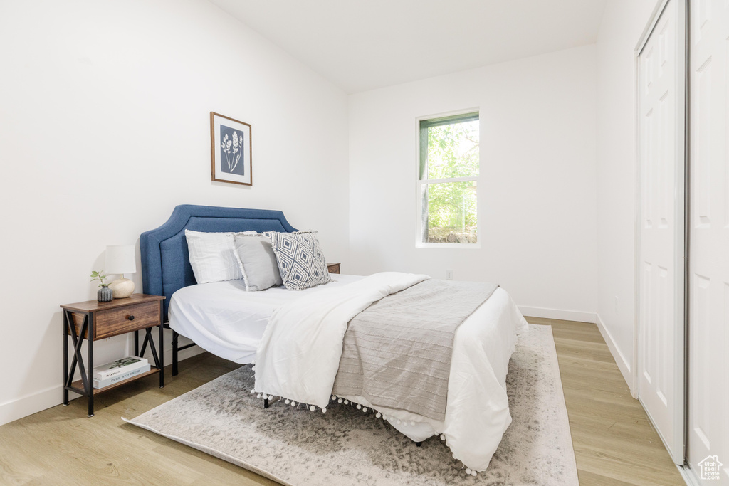 Bedroom featuring light wood-style flooring and a closet