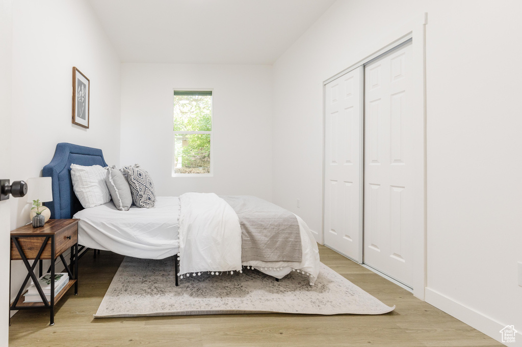 Bedroom featuring light wood-style floors and a closet