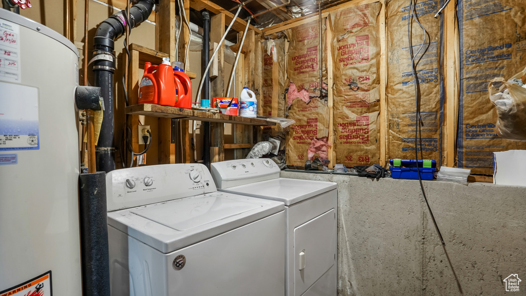 Laundry room featuring water heater and separate washer and dryer