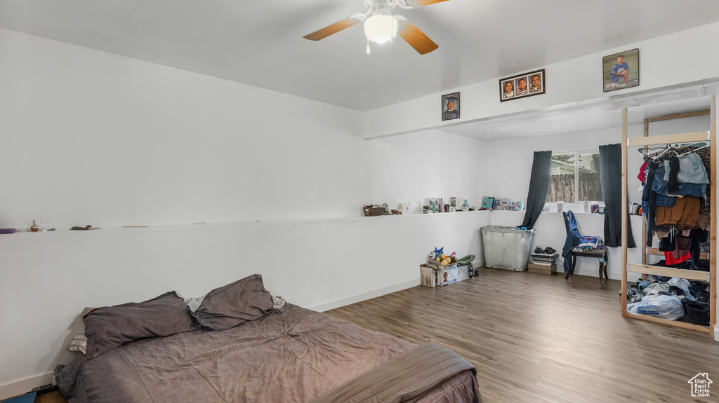 Bedroom featuring wood finished floors and a ceiling fan