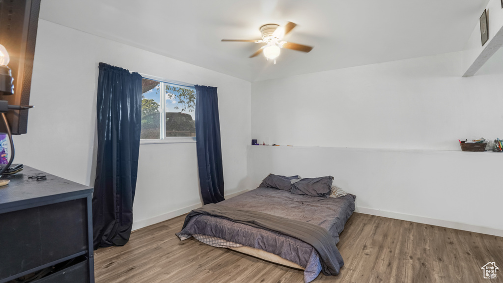 Bedroom featuring wood finished floors and a ceiling fan