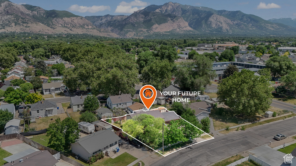 Aerial perspective of suburban area featuring property parcel outlined and mountains