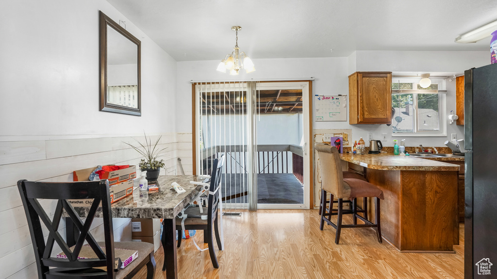 Dining space featuring light wood-style floors and a chandelier