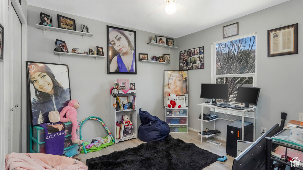 Office with wood finished floors and ceiling fan