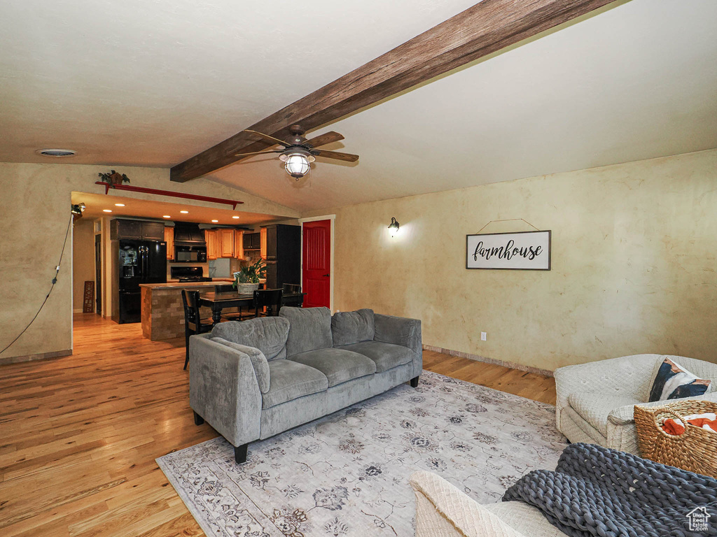 Living area with light wood-type flooring and ceiling fan