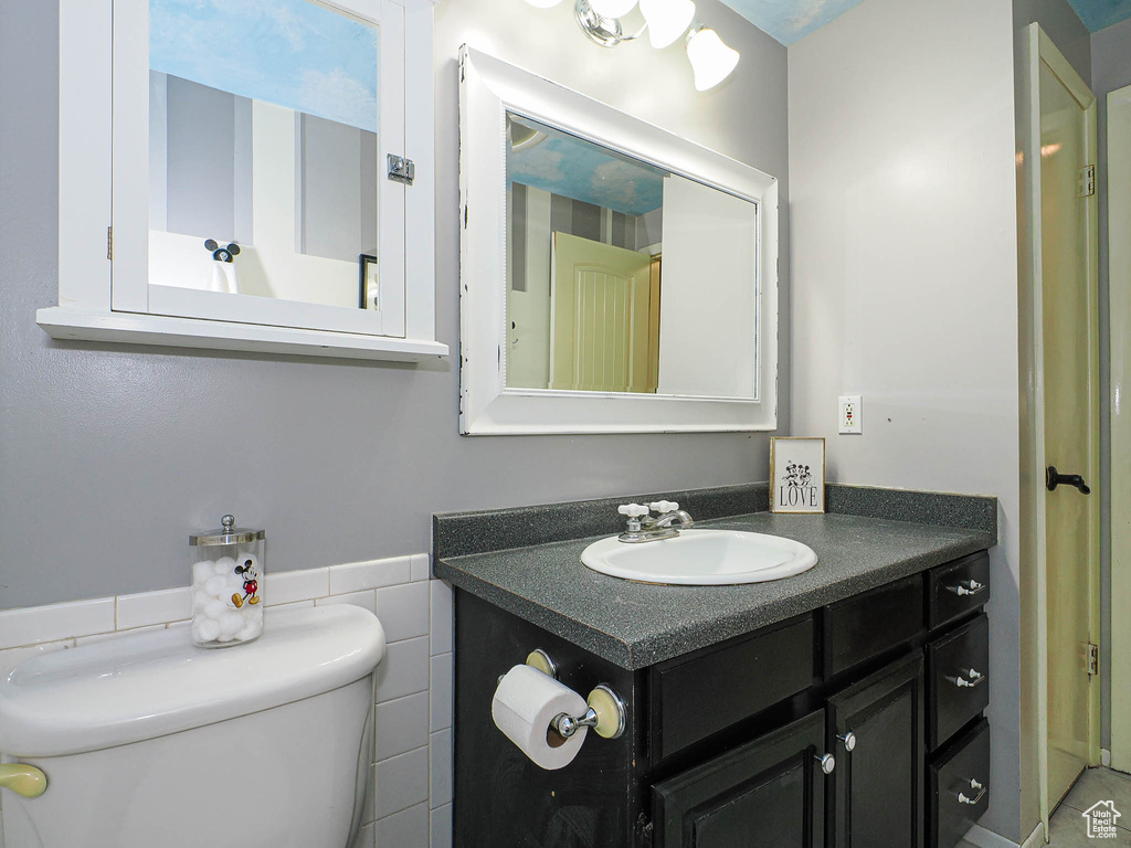 Half bathroom with toilet and vanity