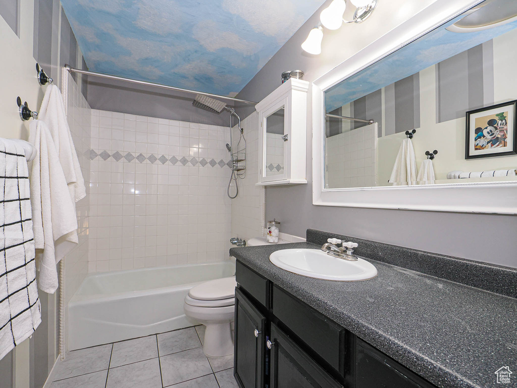 Bathroom with shower / washtub combination, vanity, and tile patterned floors