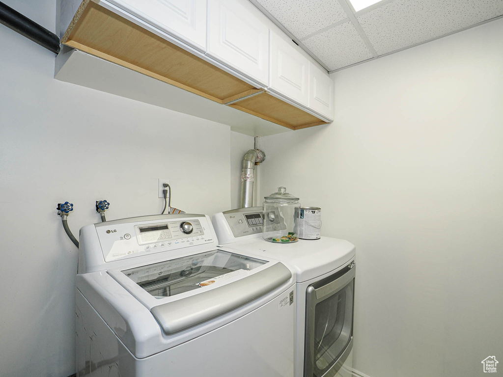 Laundry area featuring washer and dryer and cabinet space
