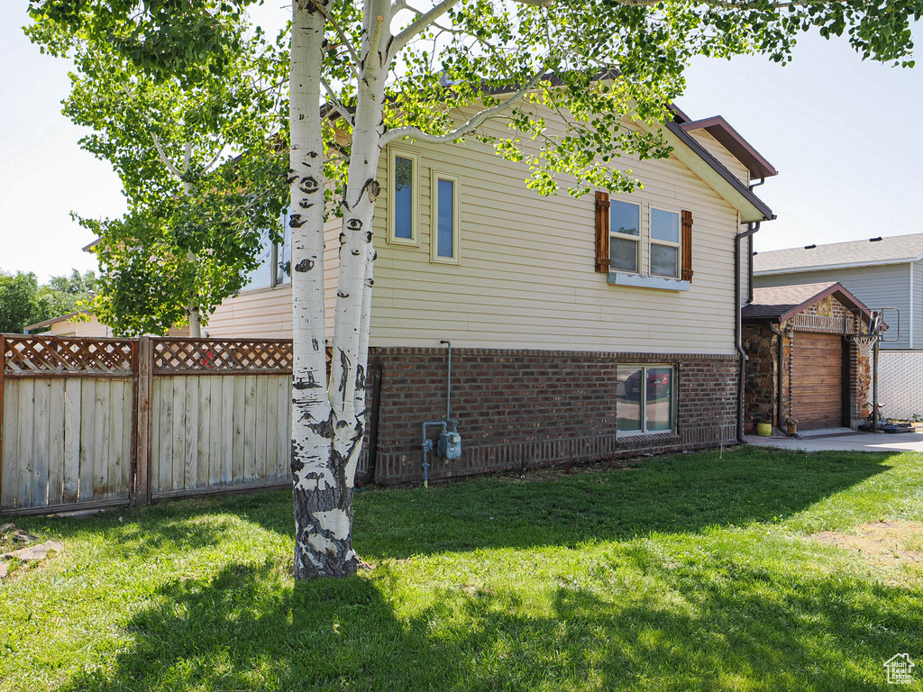 View of home\'s exterior with brick siding and a garage