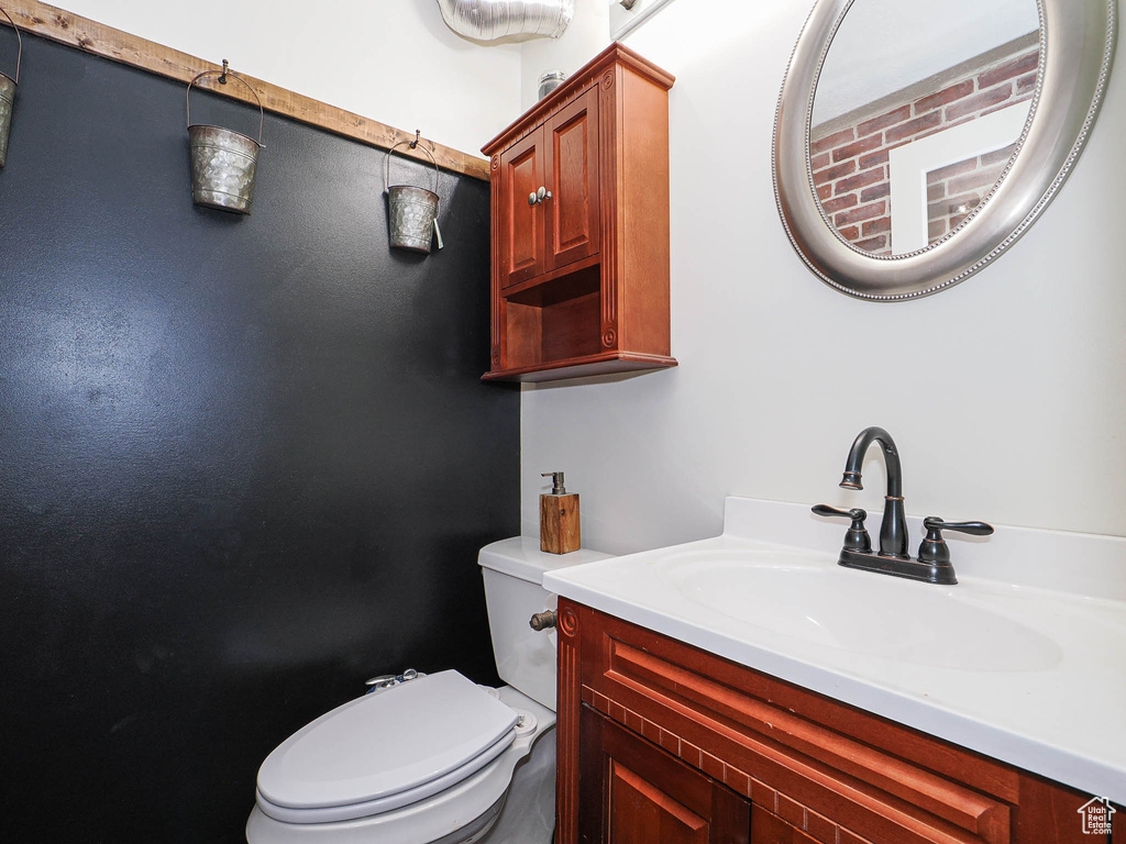 Half bathroom featuring toilet and vanity