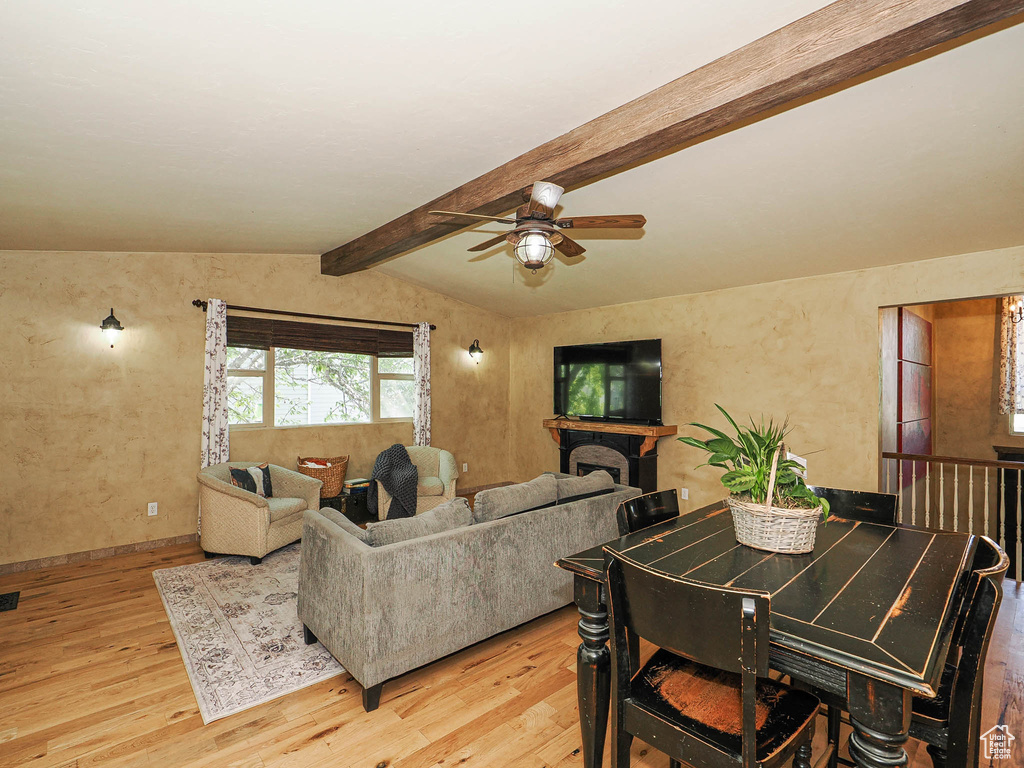 Living area with a ceiling fan and light wood-type flooring