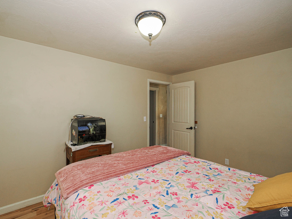 Bedroom featuring light wood-style floors and baseboards
