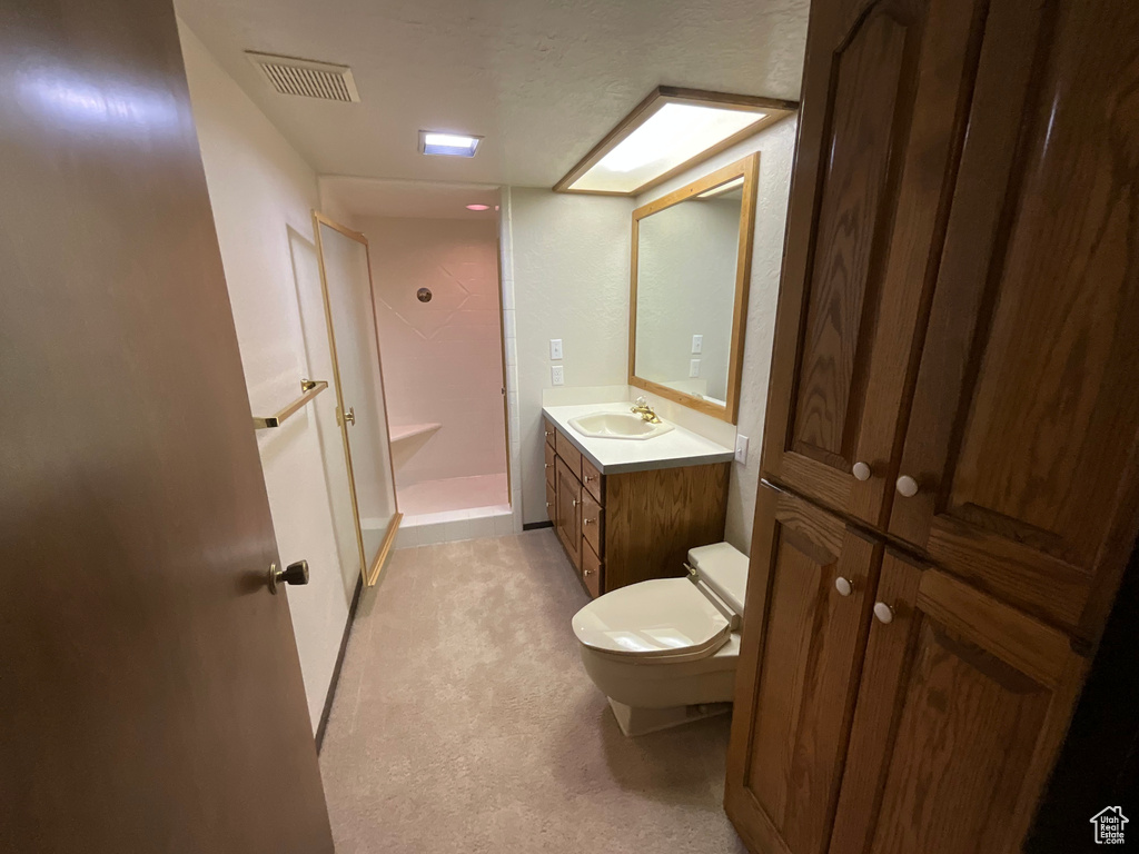 Full bath with a shower stall and vanity