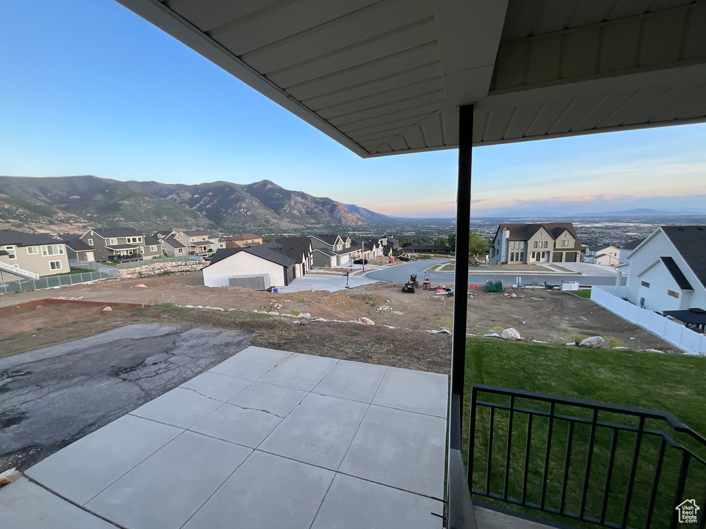 Patio terrace at dusk with a mountain view and a residential view