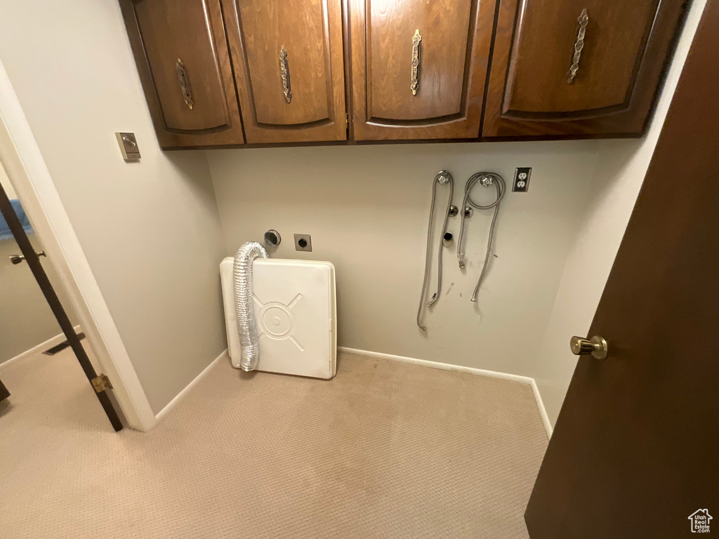 Laundry room featuring hookup for an electric dryer, carpet, and cabinet space