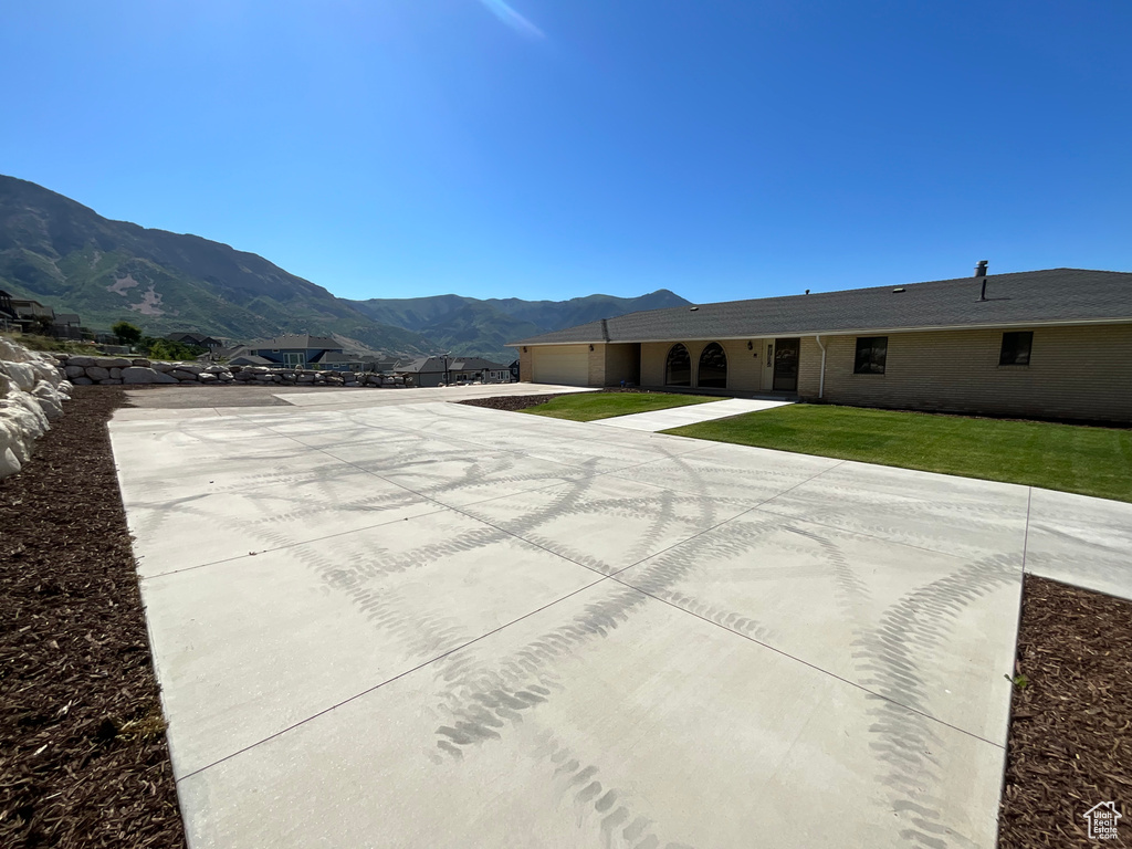 View of pool with a mountain view and a lawn