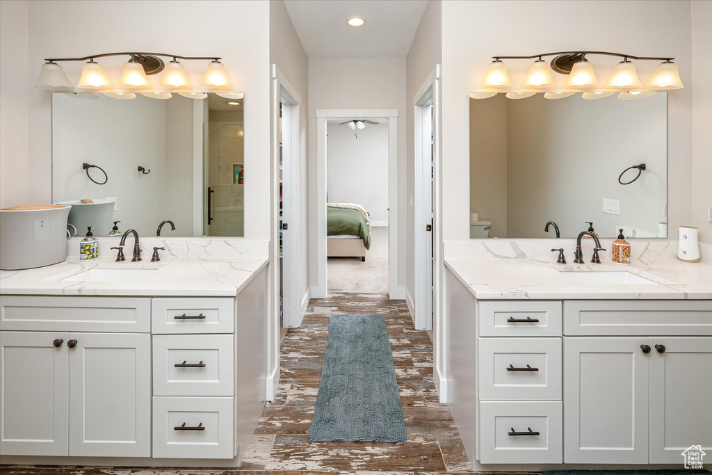 Full bathroom with two vanities, ensuite bathroom, a shower, and recessed lighting