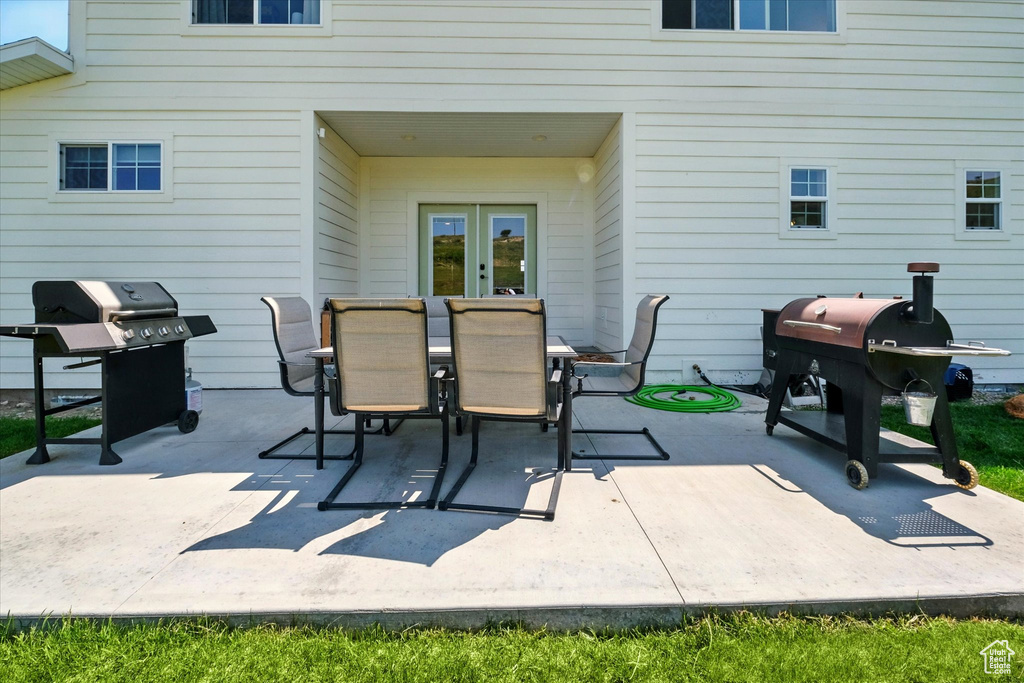 View of patio / terrace with a grill and outdoor dining area