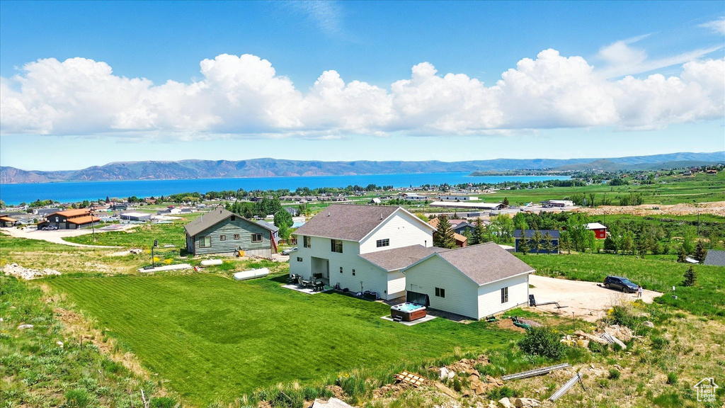 View from above of property with a water and mountain view