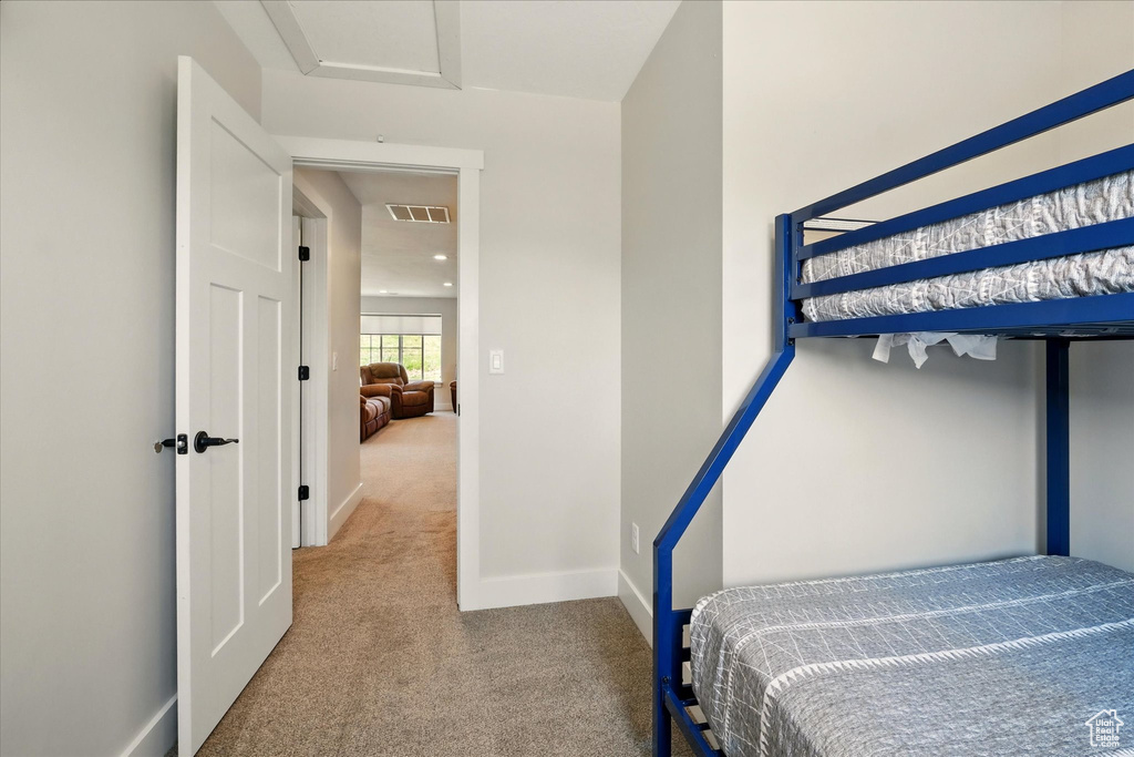 Bedroom with carpet floors and attic access