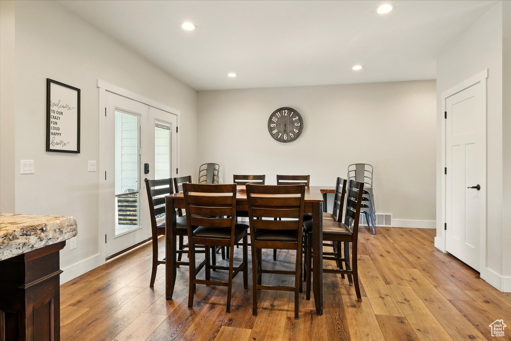 Dining area with recessed lighting and wood-type flooring