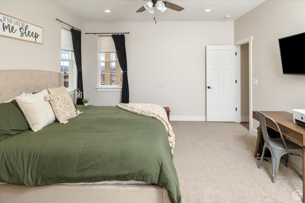 Carpeted bedroom featuring recessed lighting and a ceiling fan