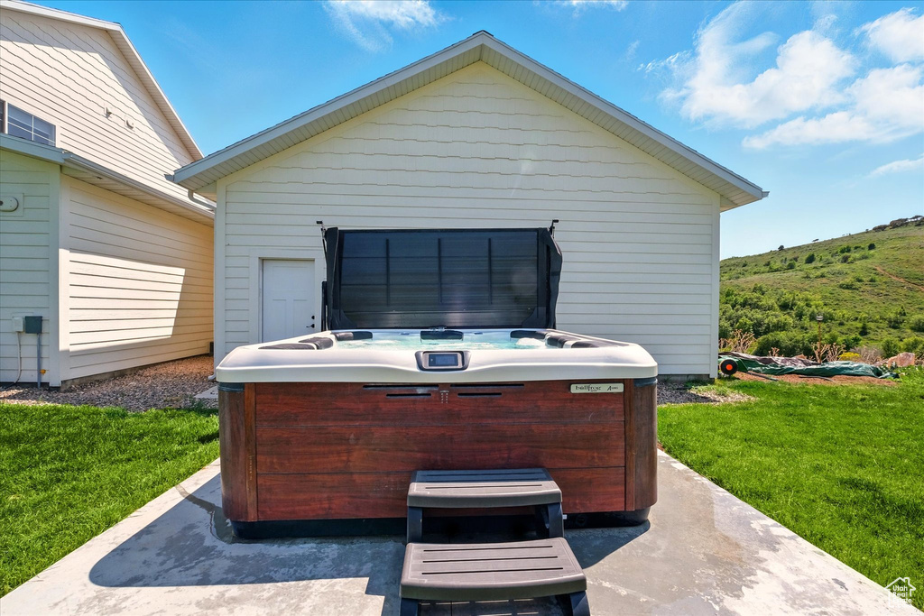 View of patio featuring a hot tub