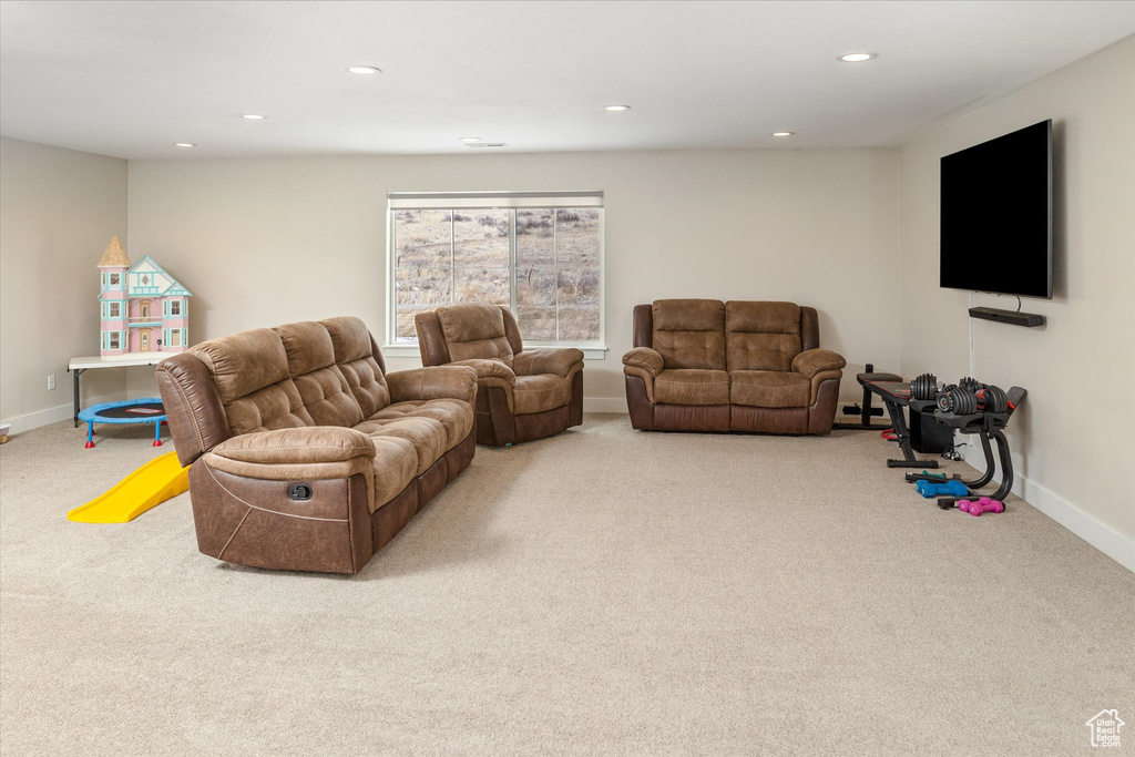 Carpeted living room featuring recessed lighting and baseboards