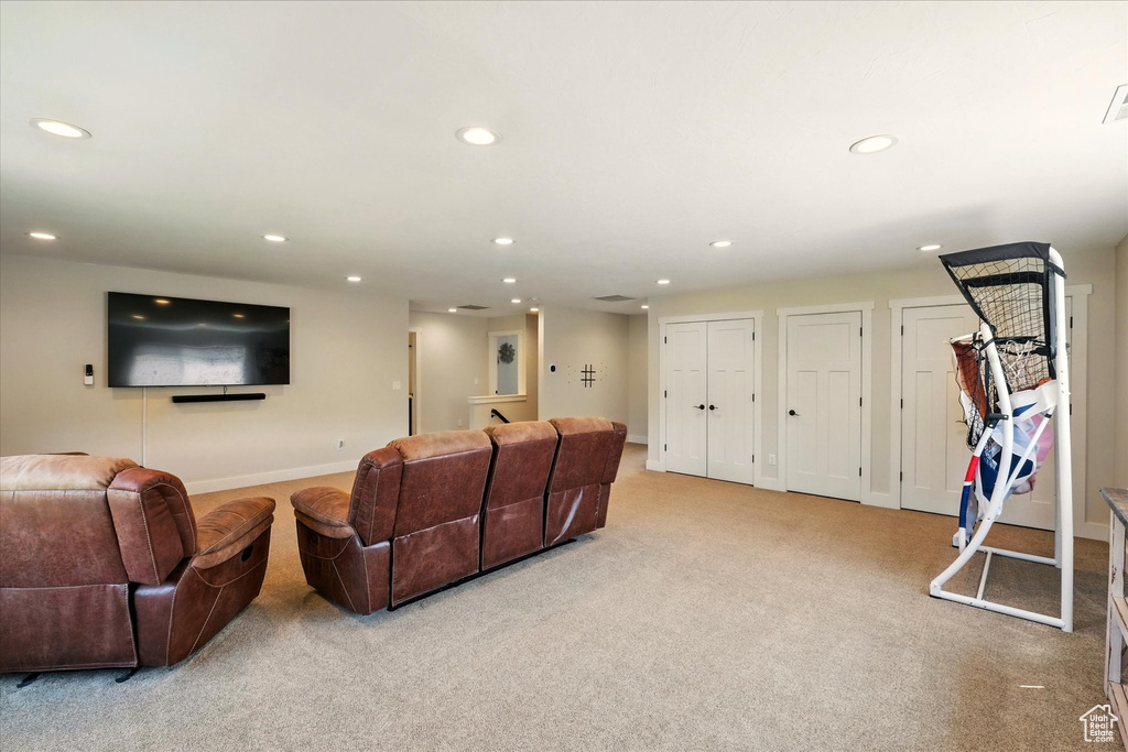 Living area with recessed lighting and light colored carpet