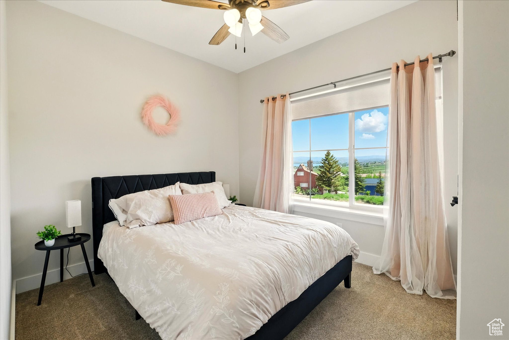 Bedroom with carpet floors and a ceiling fan