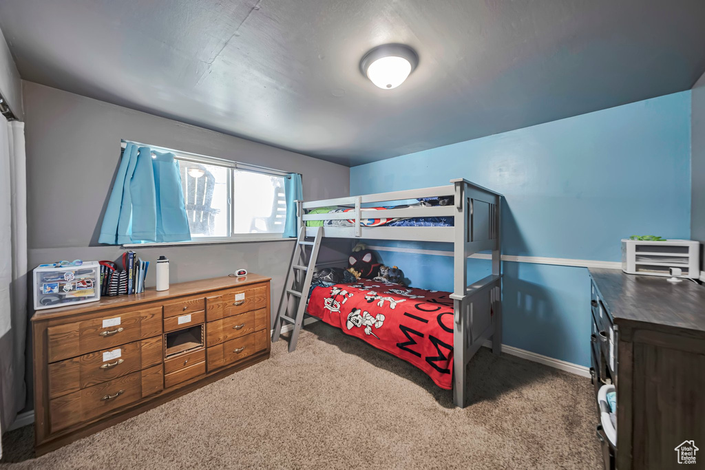 Bedroom featuring carpet flooring and a desk