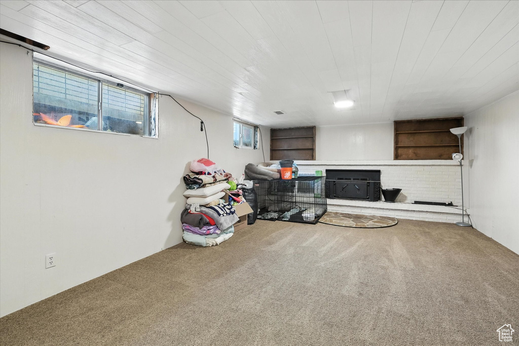 Below grade area featuring carpet floors and wooden ceiling