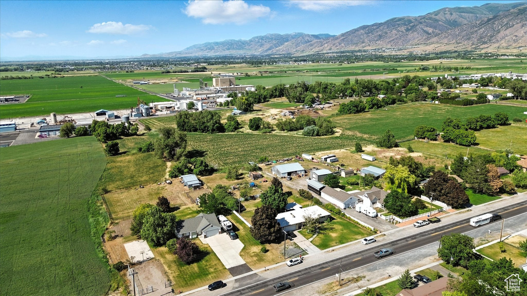 Aerial view of property and surrounding area with rural landscape and a mountain backdrop