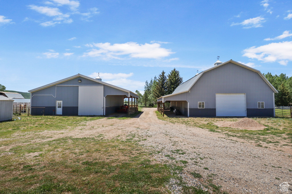 View of pole building featuring driveway