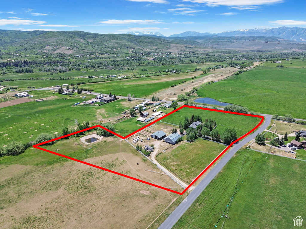 Overview of rural landscape with mountains and property parcel outlined