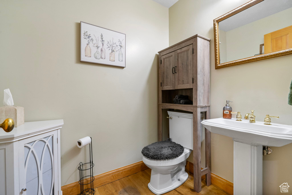 Bathroom featuring toilet and wood finished floors