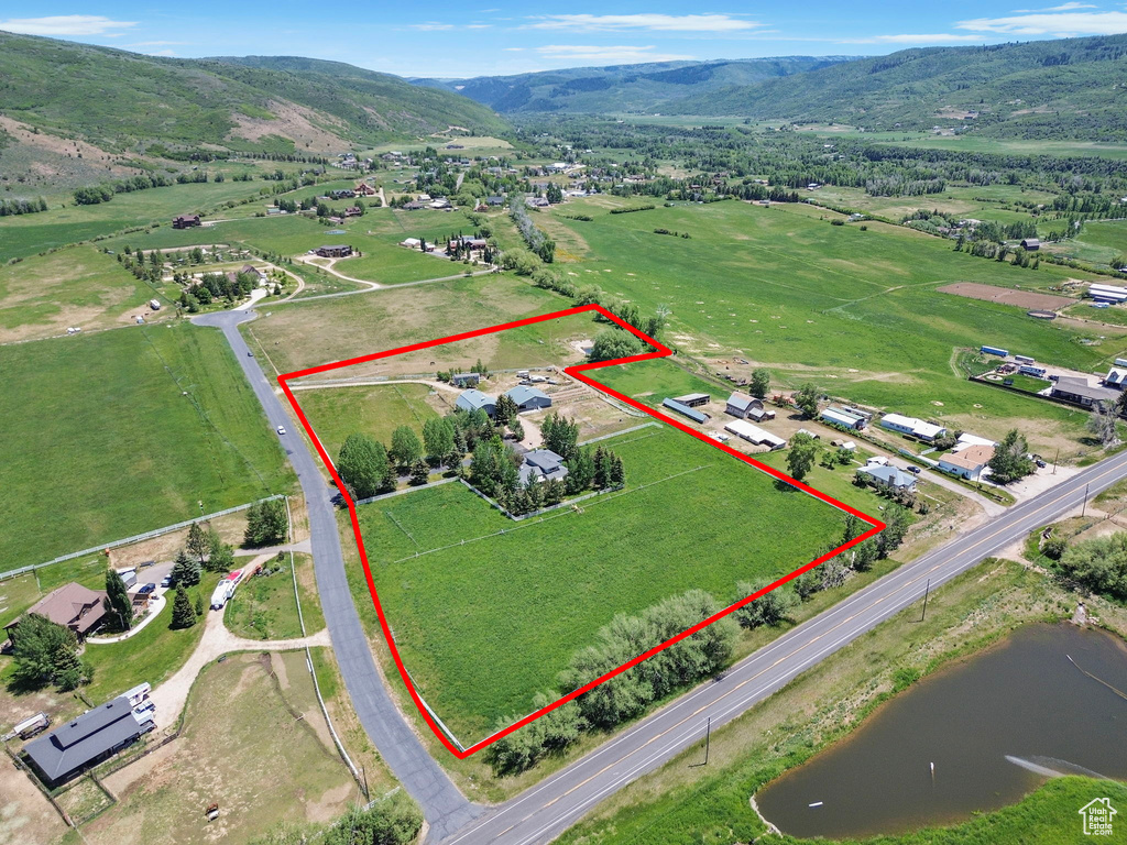 Aerial view of property's location featuring property parcel outlined and a water and mountain view