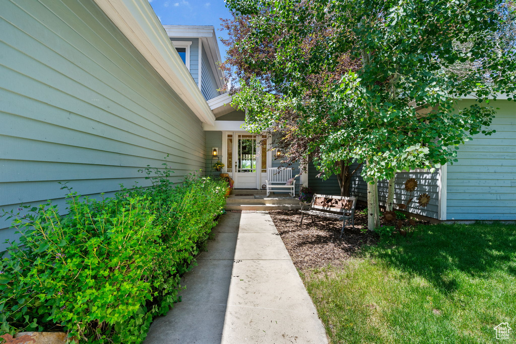 Doorway to property featuring a yard