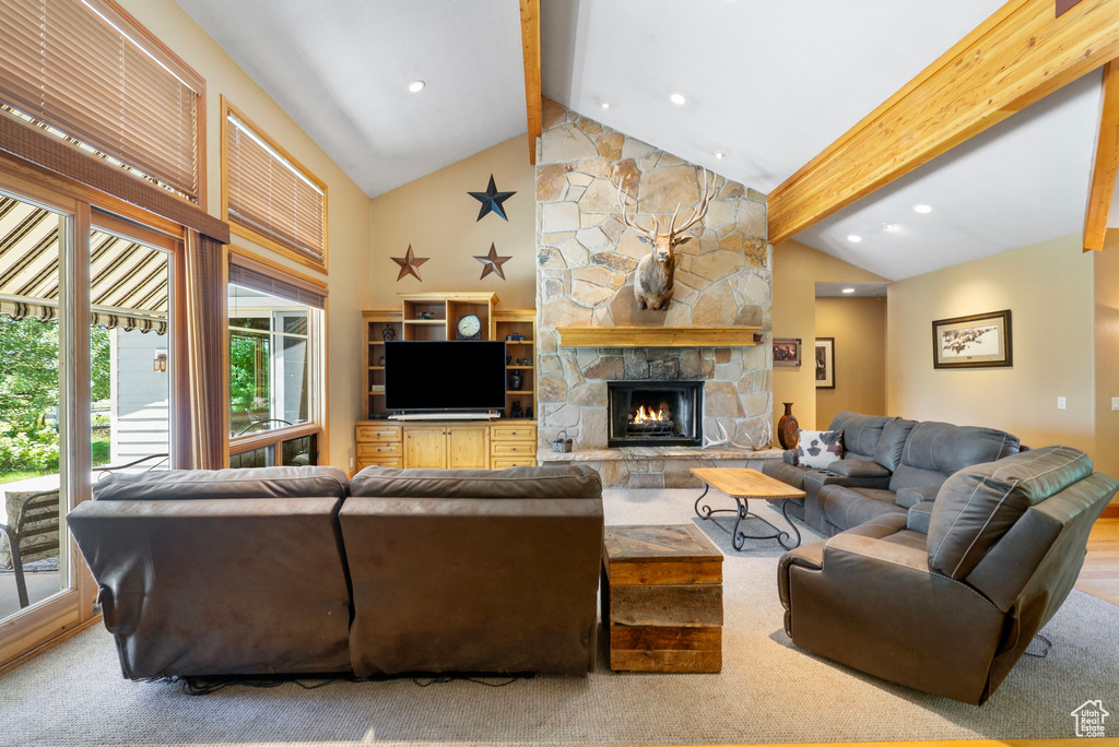 Carpeted living room with beamed ceiling, a fireplace, recessed lighting, and high vaulted ceiling