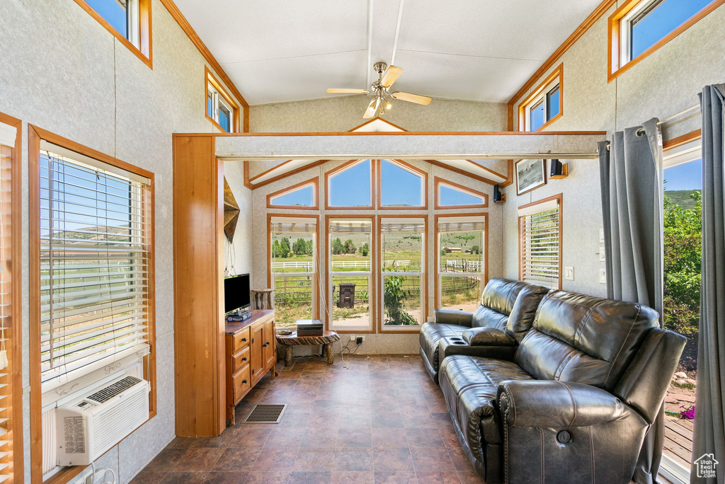 Sunroom featuring vaulted ceiling and cooling unit