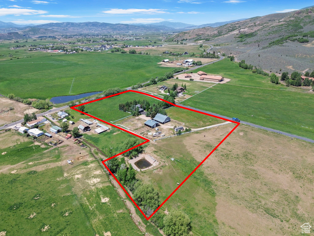 Overview of rural landscape with a mountainous background and property boundaries highlighted