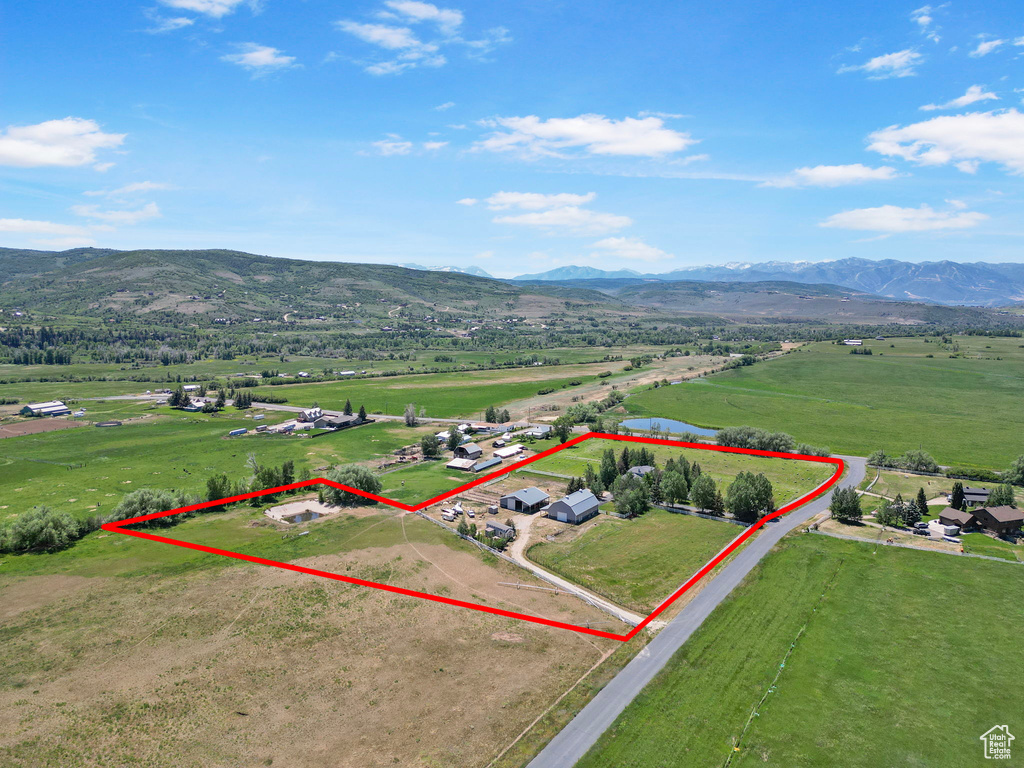 Overview of rural landscape with mountains and property parcel outlined