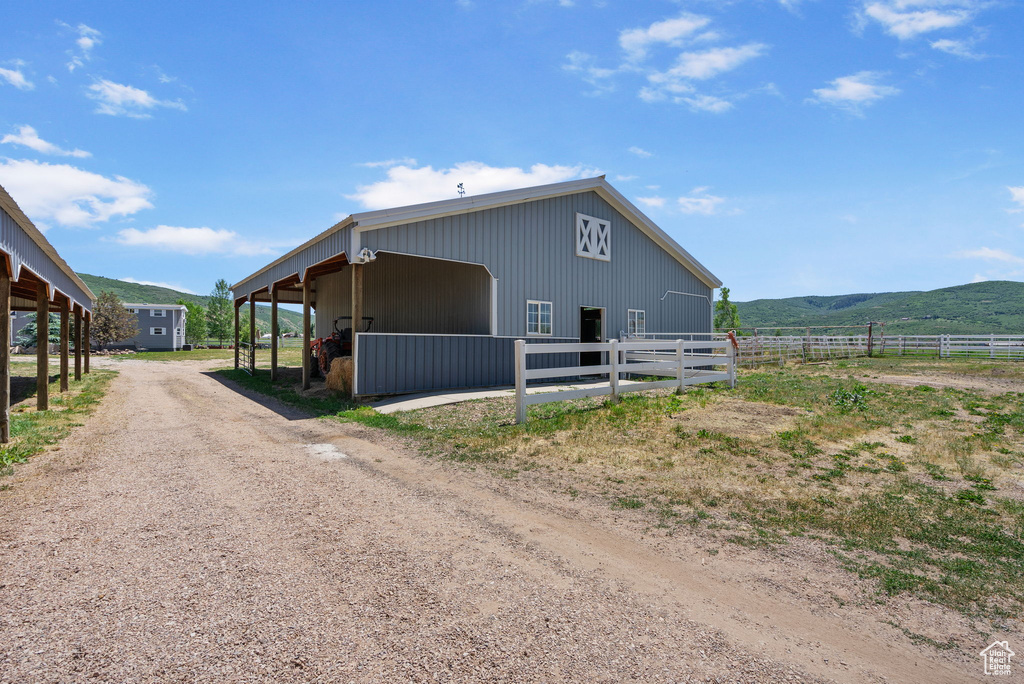 View of outdoor structure featuring an exterior structure, a mountain view, and driveway