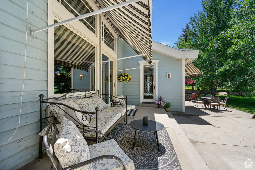 View of patio featuring an outdoor hangout area and outdoor dining area