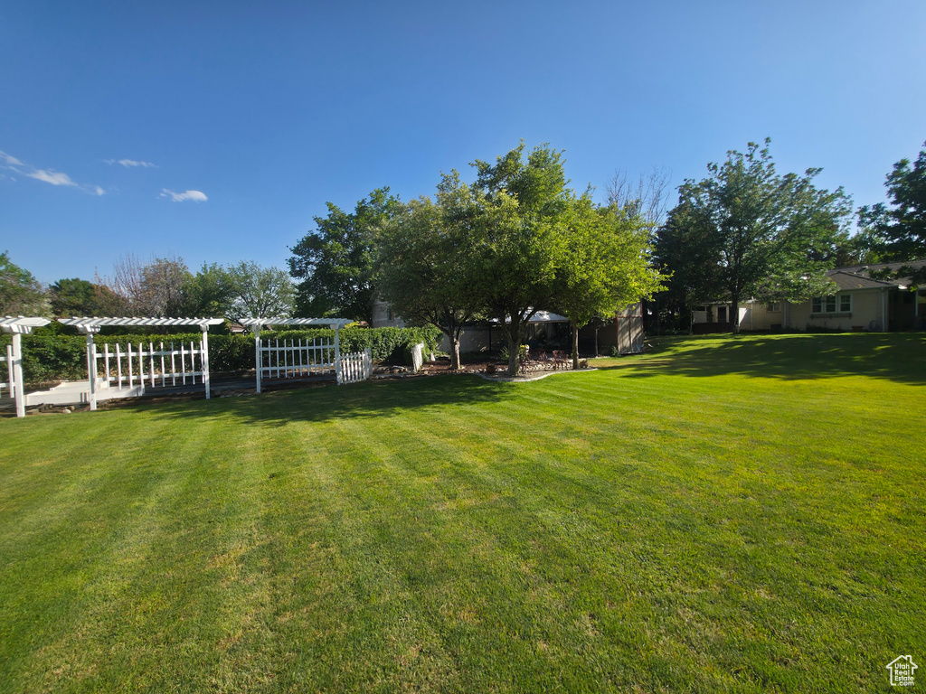 View of green lawn featuring a pergola
