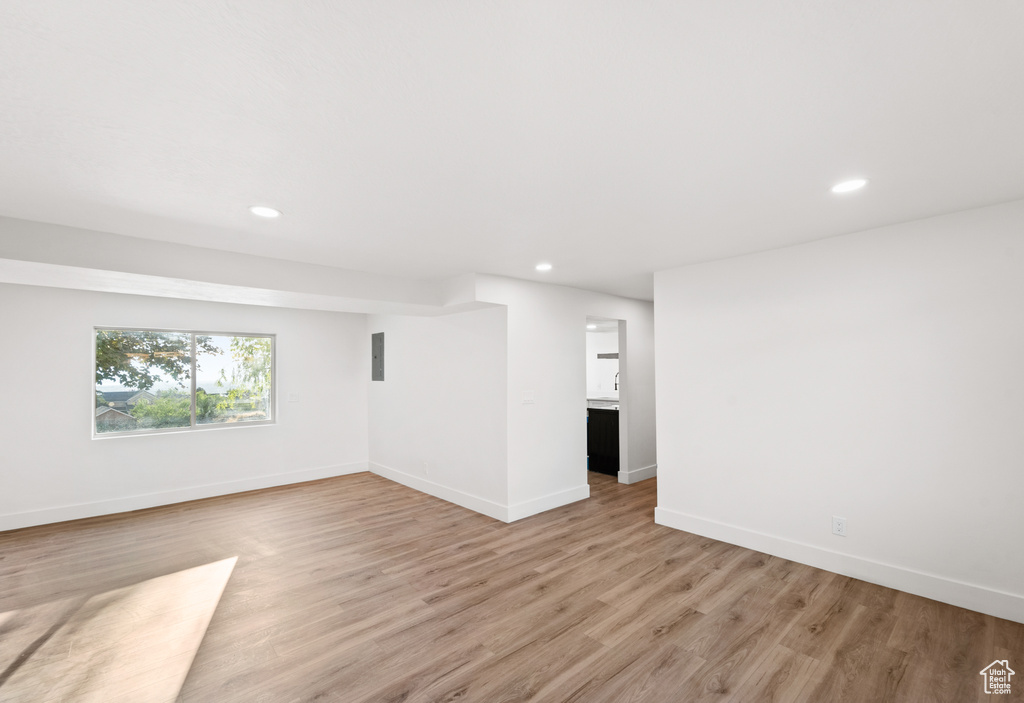 Empty room with recessed lighting and light wood-style floors