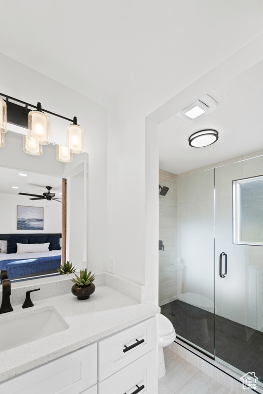Full bath featuring vanity, a shower stall, tile patterned flooring, ensuite bath, and a ceiling fan